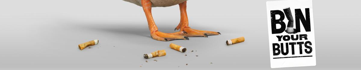 A duck's feet surrounded by cigarette butts. Text reads "Bin your butts"